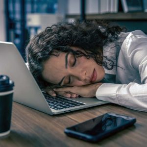 donne lavoratrici stanche che dormono alla scrivania dell'ufficio